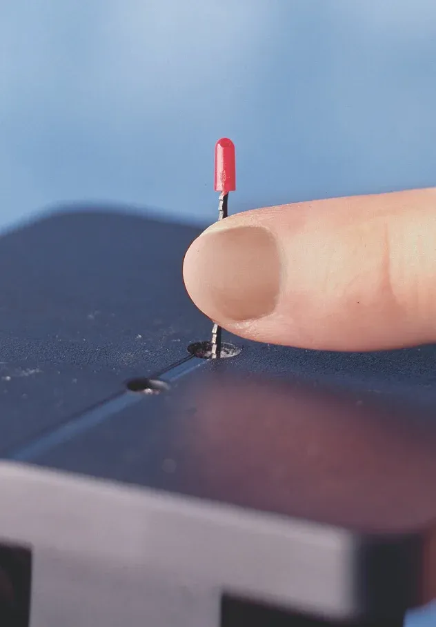 A finger touching the PLAYmake jigsaw blade
